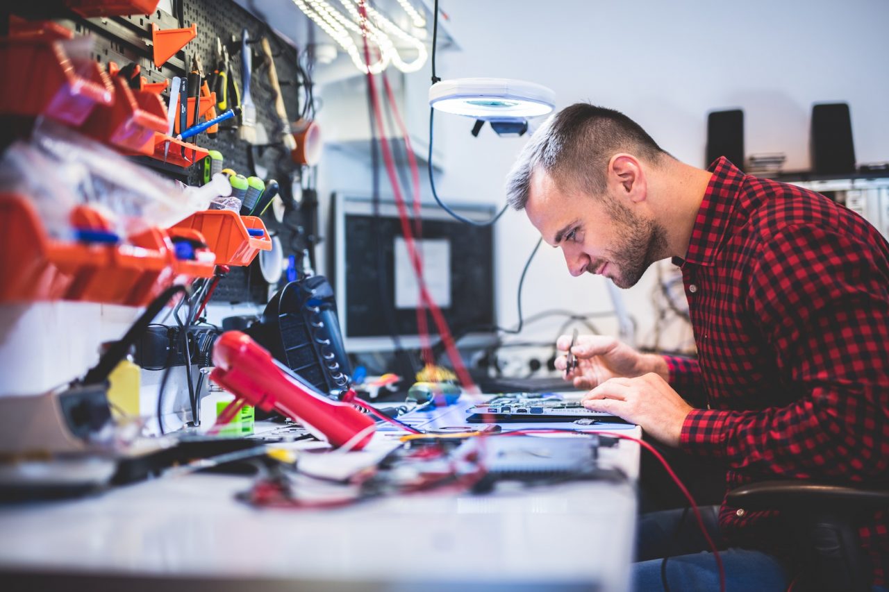 Man repairing laptop at workplace.jpg
