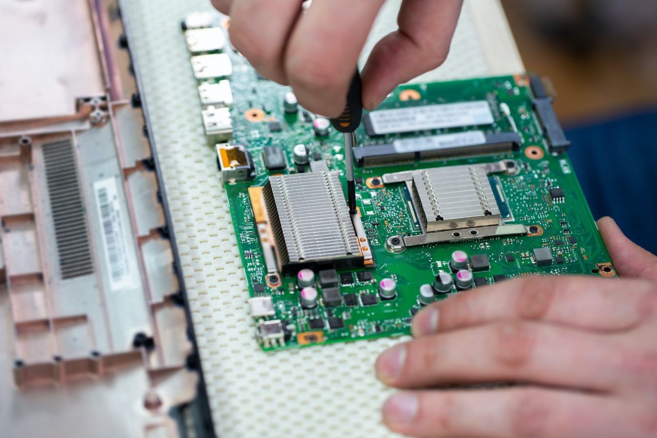 Service center for laptop repair macro of a screwdriver holding a screw .jpg
